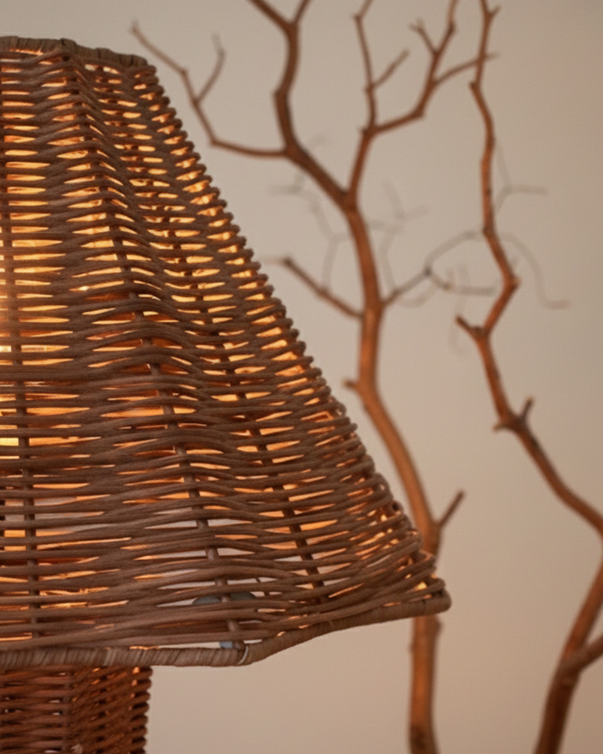 Wicker lampshade with a warm glow against a neutral background