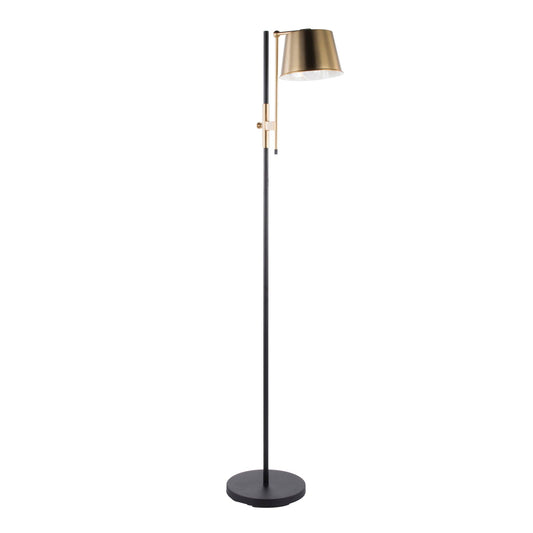 The Mercer Adjustable Floor Lamp featuring a matte black metal frame and antique brass adjustable shade, styled beside a leather Chesterfield sofa in a refined coastal library with built-in bookcases, weathered oak furnishings, and warm brass accents.