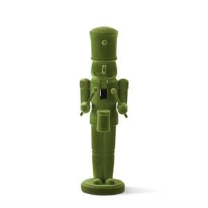 An olive green nutcracker figurine standing upright on a white background.