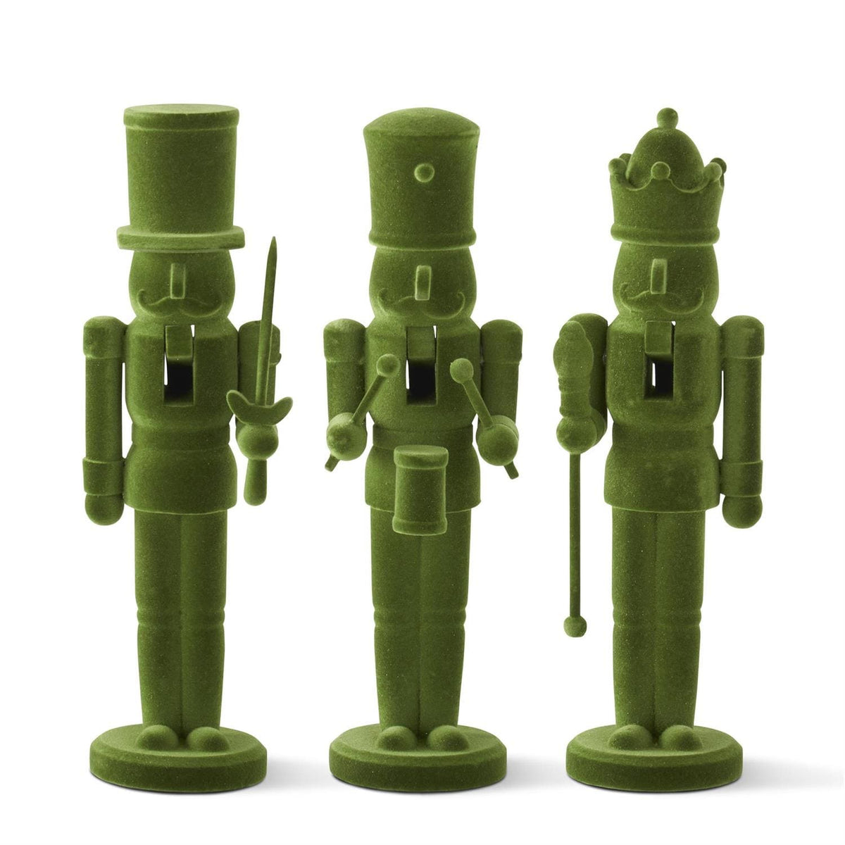 Three green nutcracker figurines on a white background