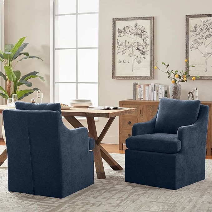 Navy blue armchairs in a living room with a wooden table and decorative elements.