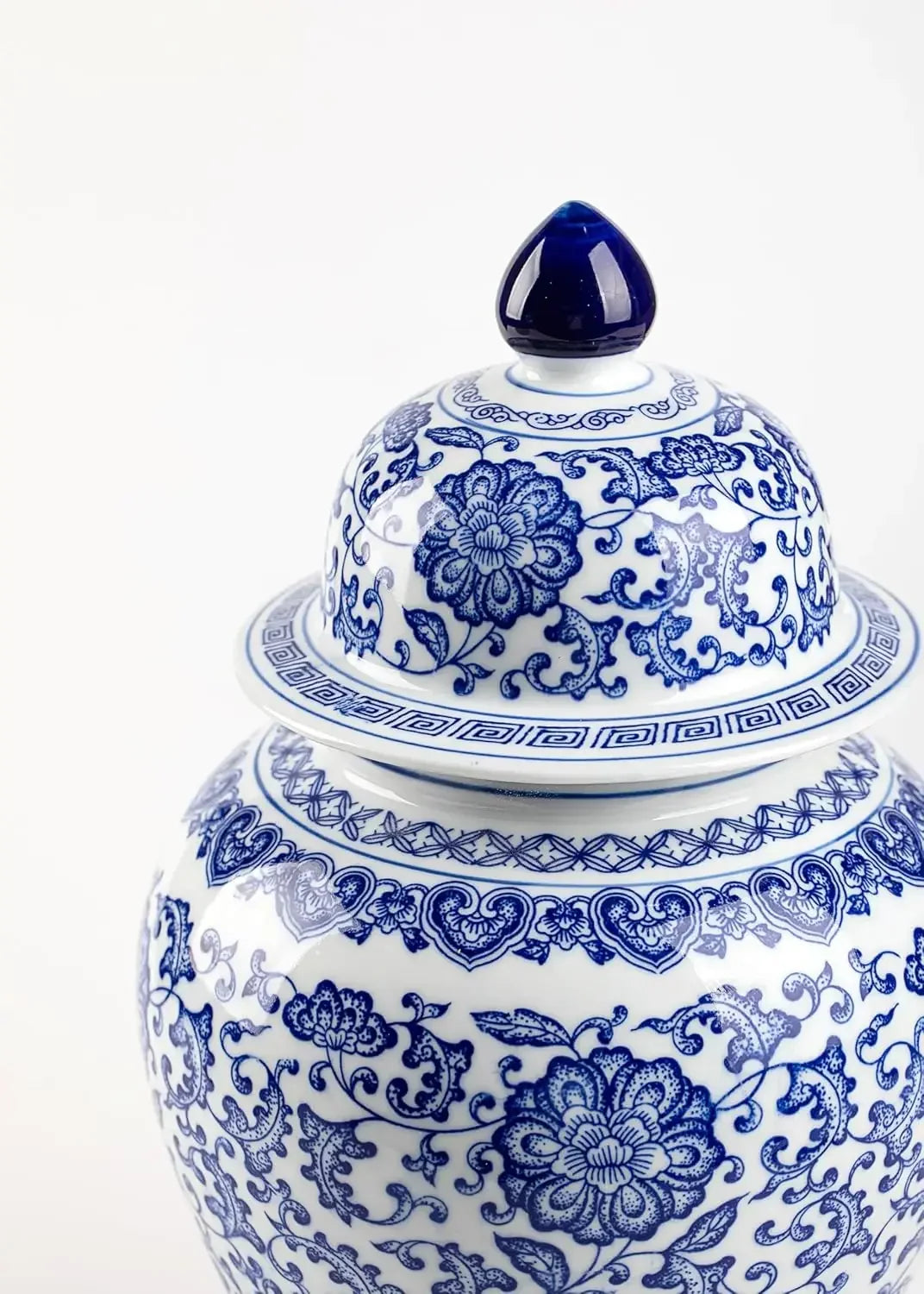 Blue and white decorative vase with intricate patterns on a white background