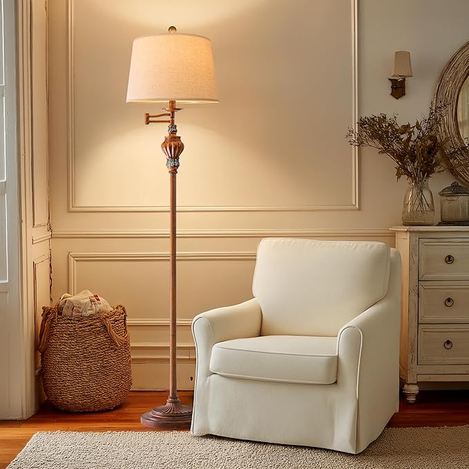 White armchair in a living room with a floor lamp and decorative elements.