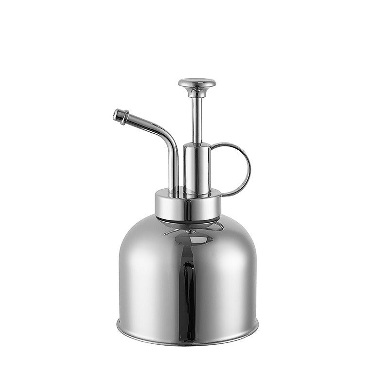 Chrome metal spray bottle on a white background