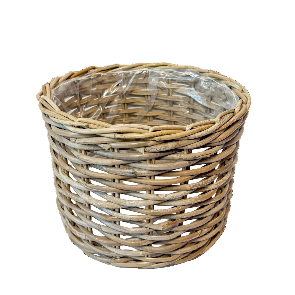 A natural woven wicker basket with a clear plastic liner inside, shown on a plain white background.