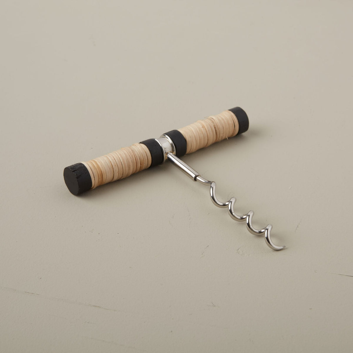 Corkscrew with wooden handle on a beige background