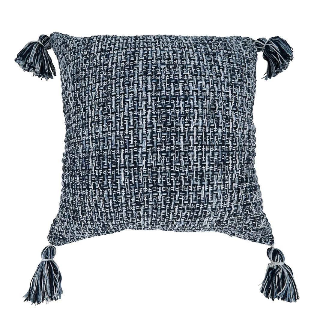A square woven throw pillow in a textured black and white bouclé pattern, featuring four dark gray tassels on the corners, shown against a plain white background.