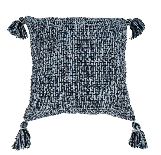 A square woven throw pillow in a textured black and white bouclé pattern, featuring four dark gray tassels on the corners, shown against a plain white background.