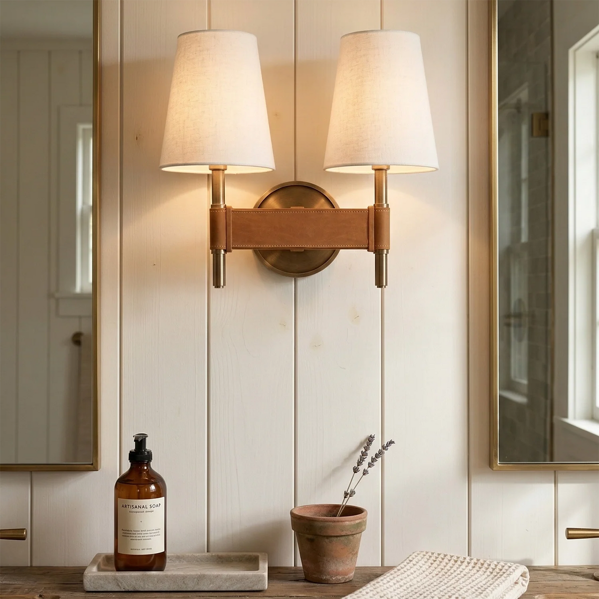 Wall-mounted lamp with a bottle and plant on a shelf in a bathroom setting