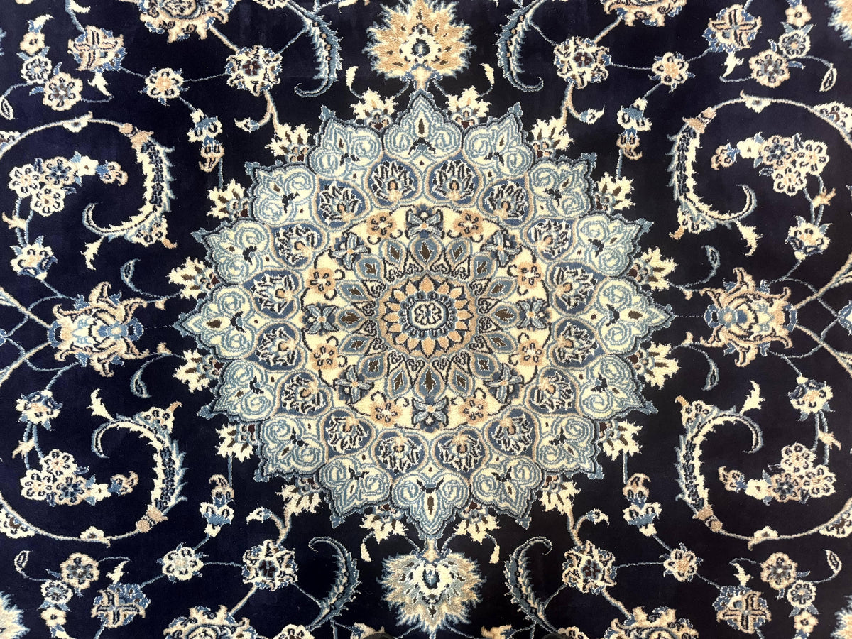 Close-up of a patterned fabric with intricate designs on a dark background