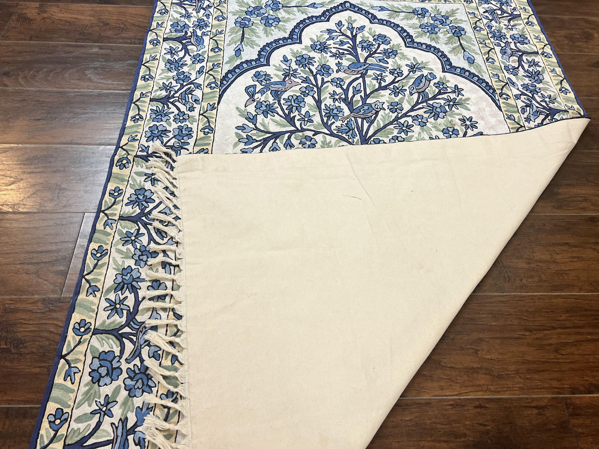 Decorative table runner with blue floral pattern on a wooden surface