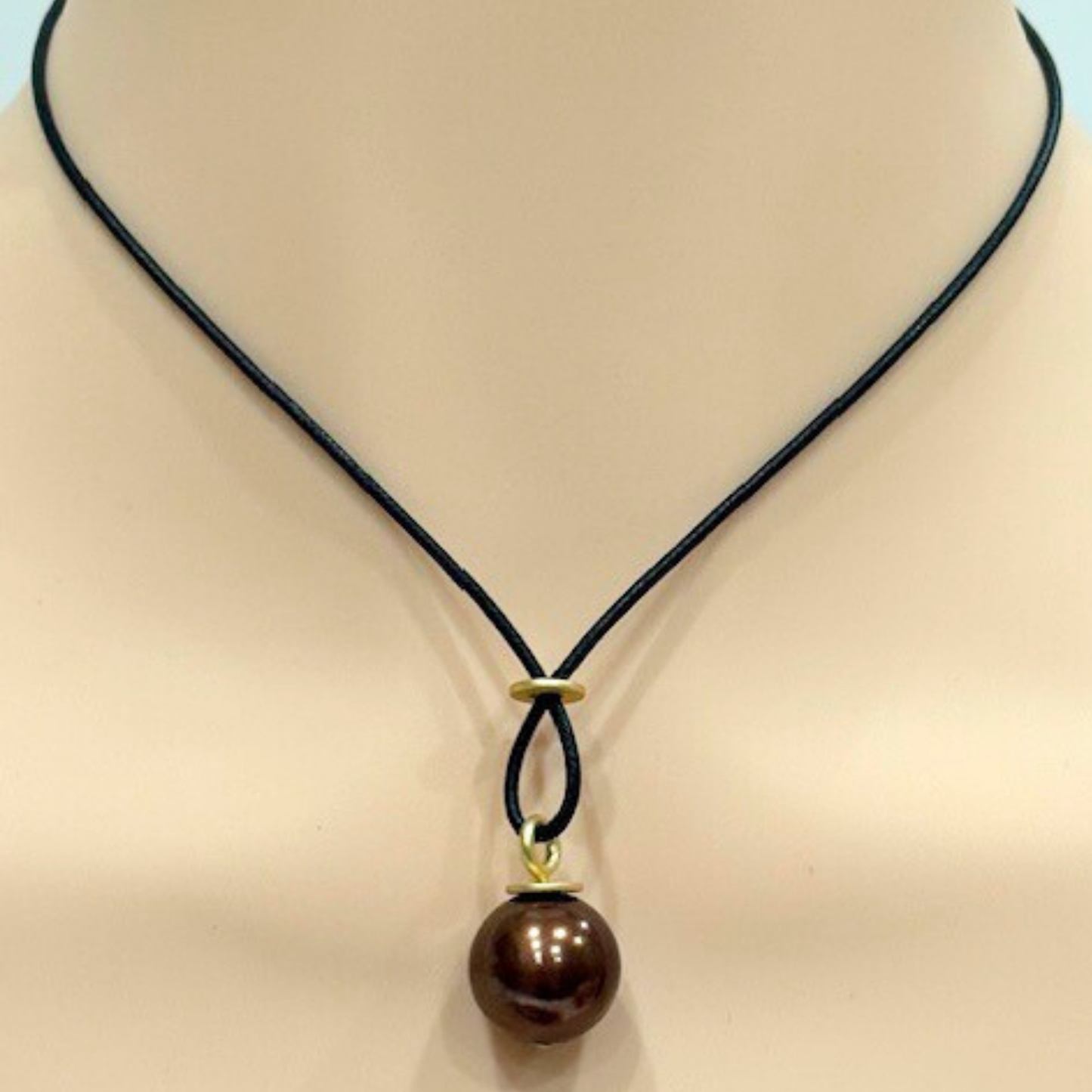 Large Chocolate Color Pearl With Criss Cross Design On Black Linen Cord