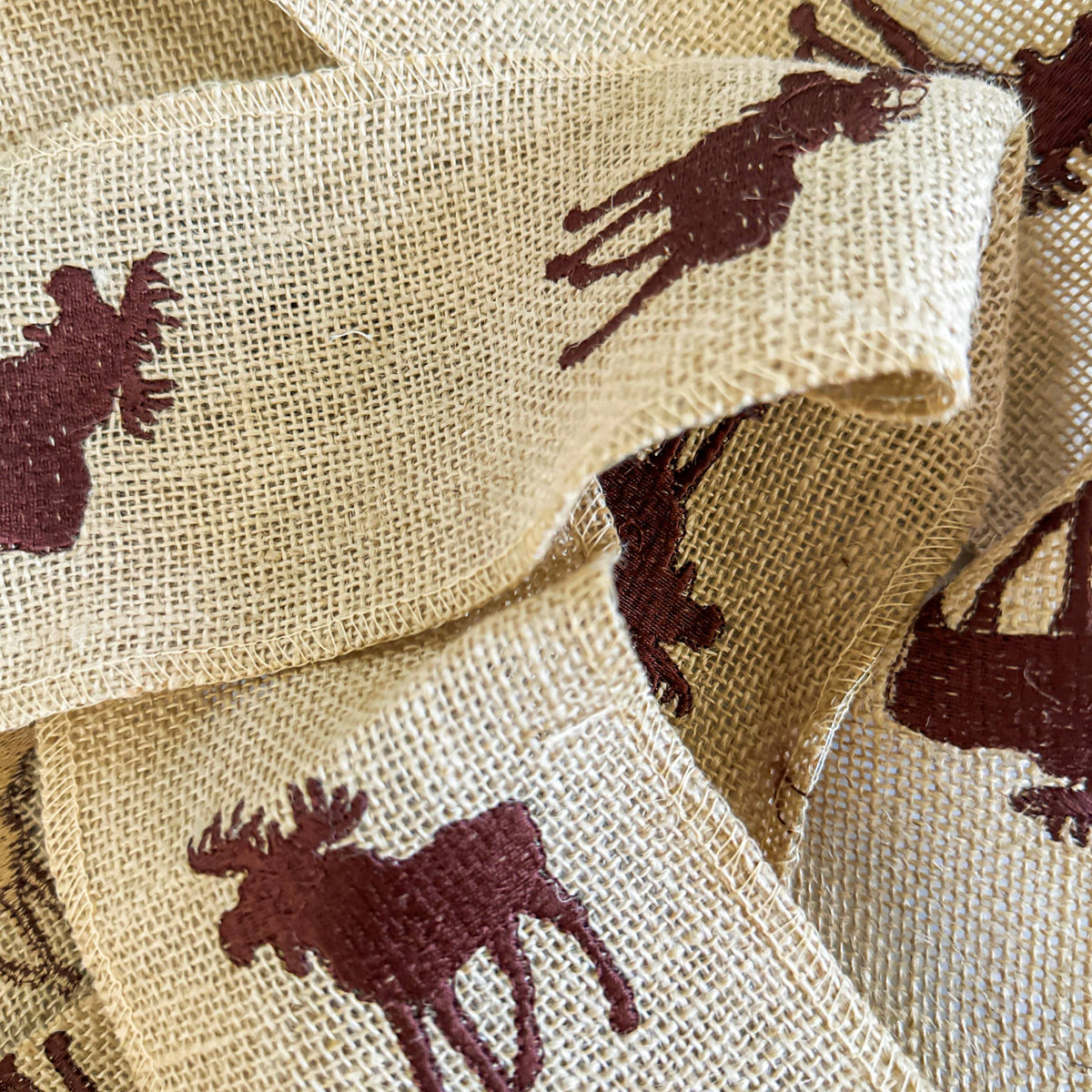 Close-up of beige fabric with brown moose patterns