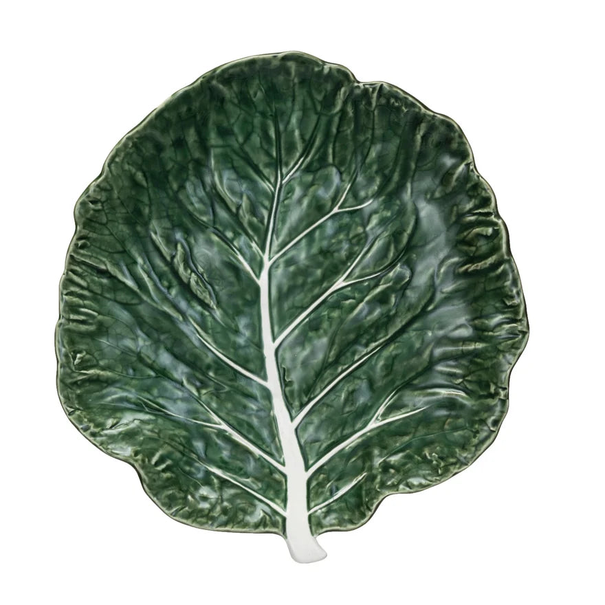 Green leaf-shaped ceramic plate on a white background